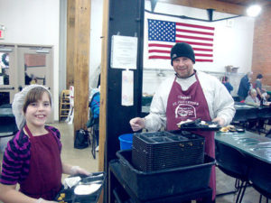 Volunteers clearing dishes