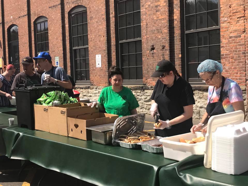 volunteers serving hot dogs outside