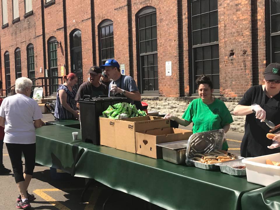 volunteers serving hot dogs outside