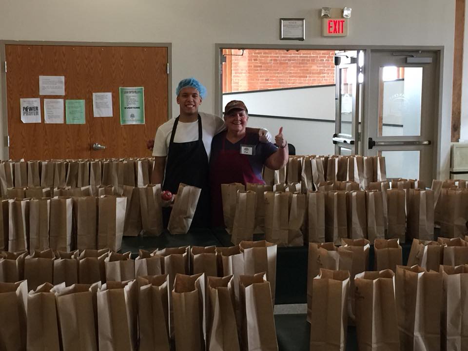 volunteers with lunch bags