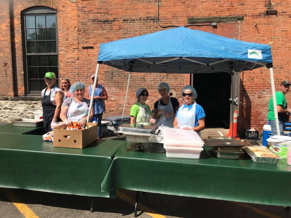 volunteers serving food outdoors